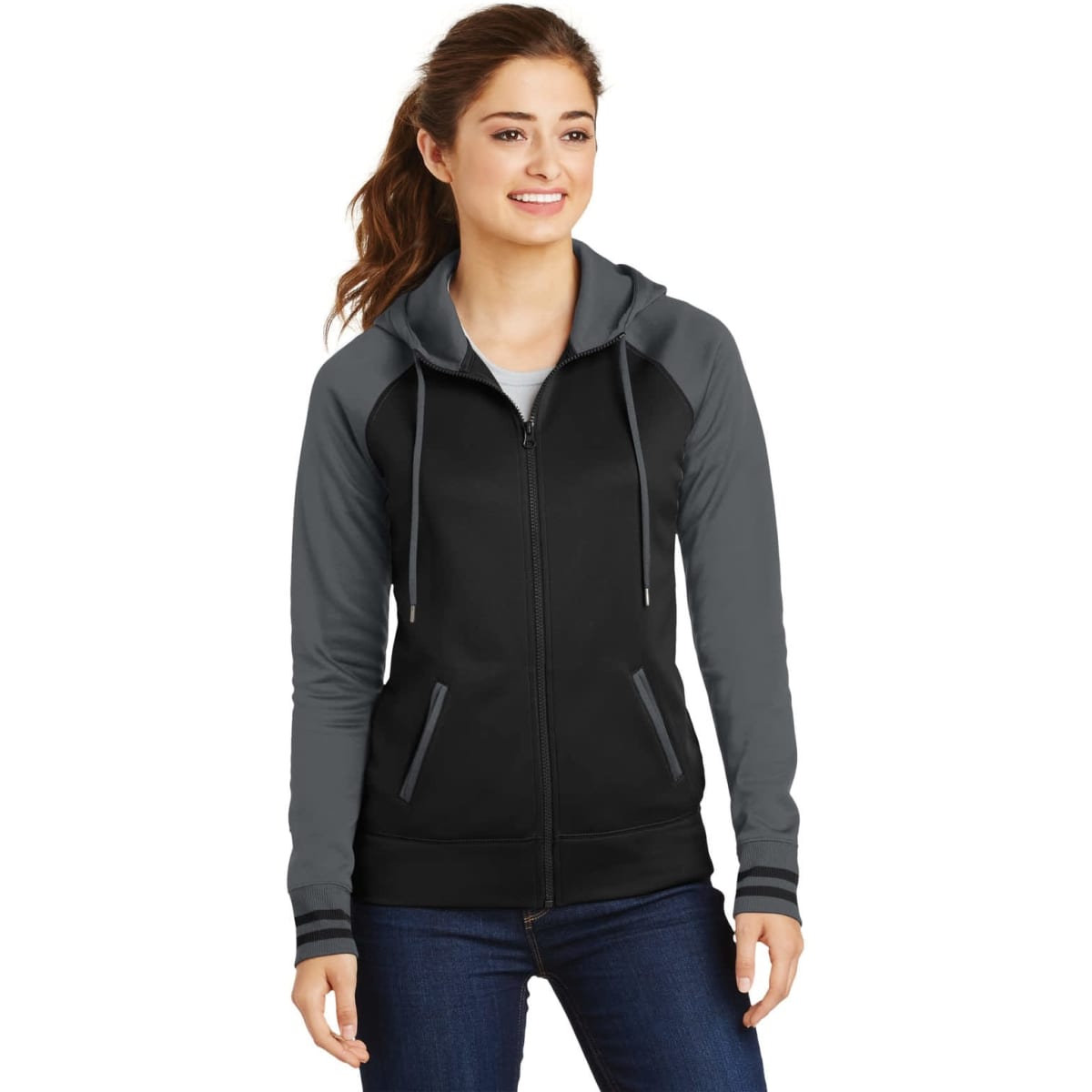 A woman models a black and grey Sport-Tek Ladies Sport-Wick Varsity Fleece Full-Zip Hooded Jacket with a hood.