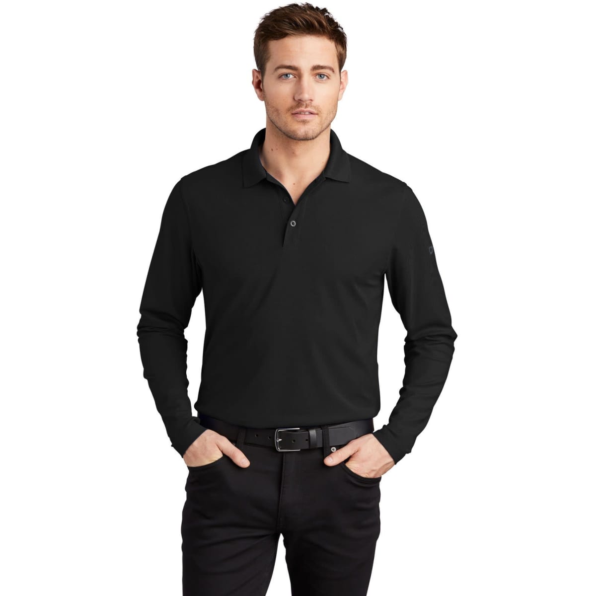 A black long sleeve shirt with a collar, featuring a logo, worn by a model with cropped hair and a belt.