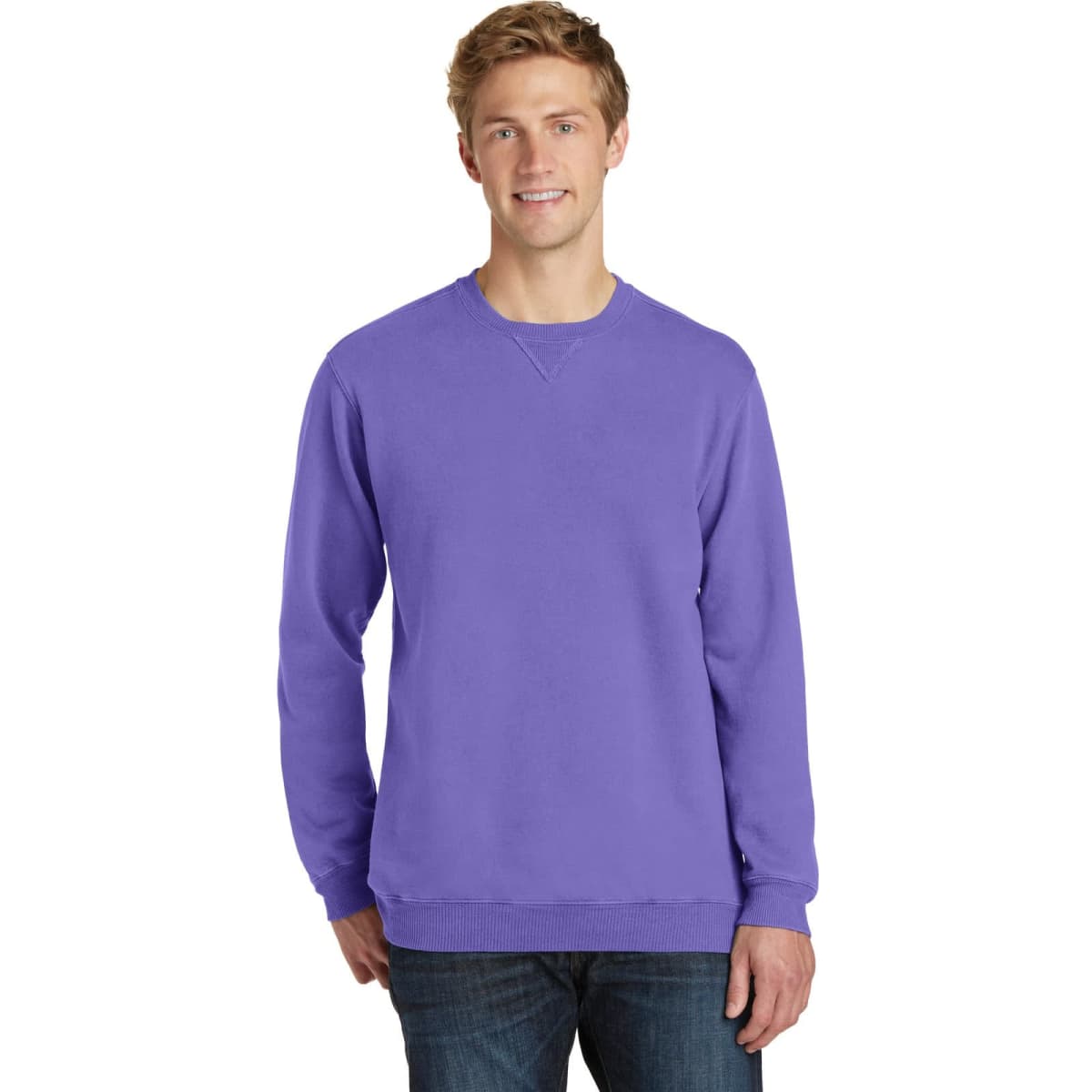 A model wearing a vibrant purple crewneck sweatshirt. The sweatshirt features a casual design and has a logo.