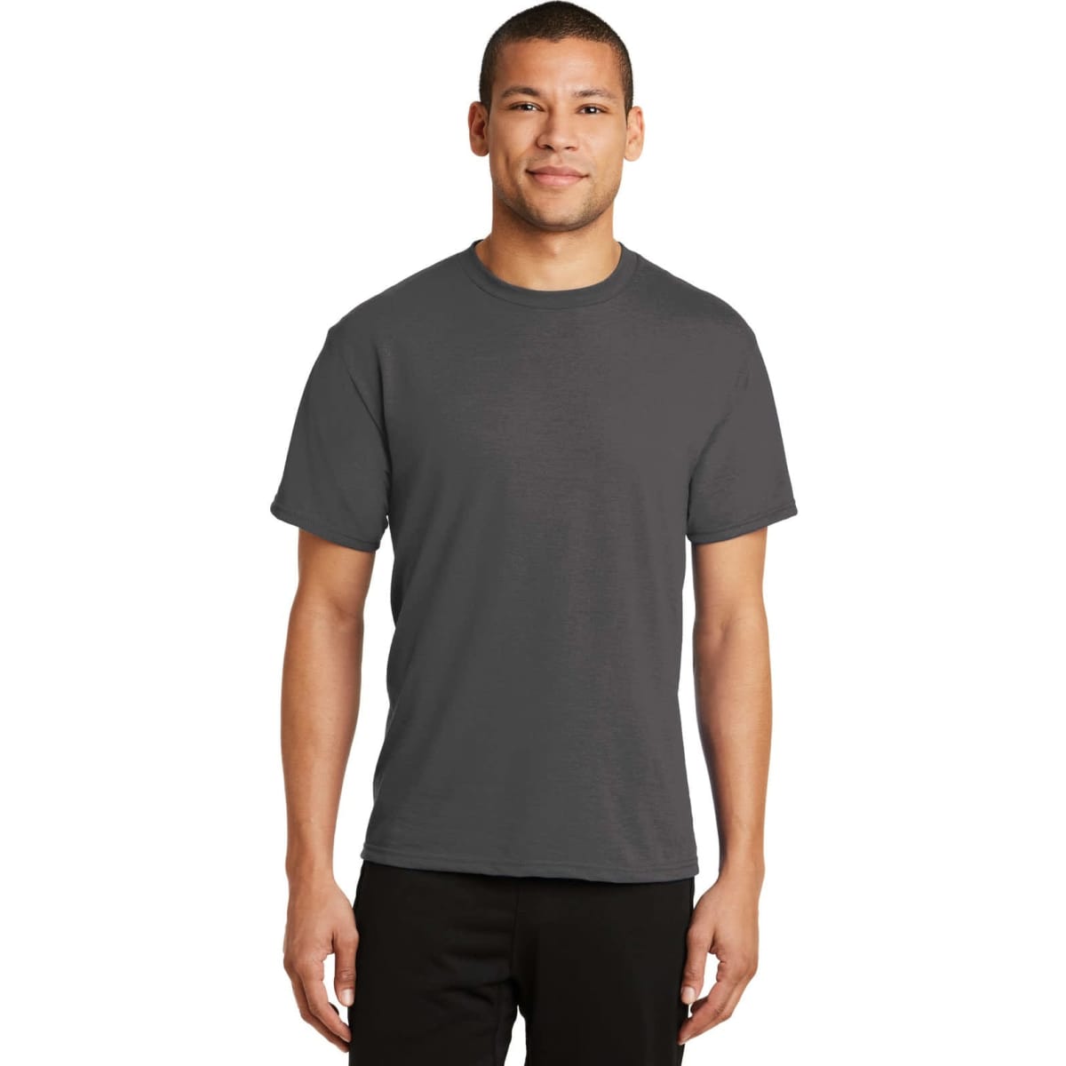 A man wearing a dark grey T-shirt. The shirt has a simple design and features a logo.