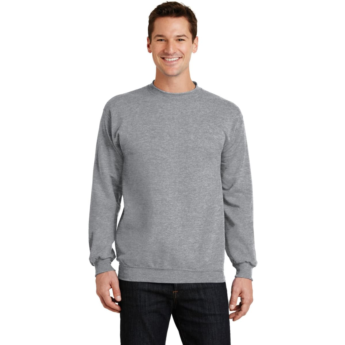 A male model is wearing a grey Port & Company Core Fleece Crewneck Sweatshirt. The sweatshirt features long sleeves and a crew neckline.