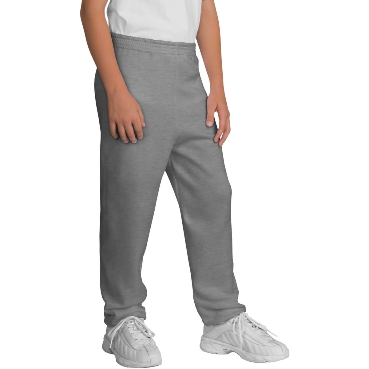 Youth core fleece sweatpants in grey, featuring an elastic waistband and a logo. Styled with white sneakers.