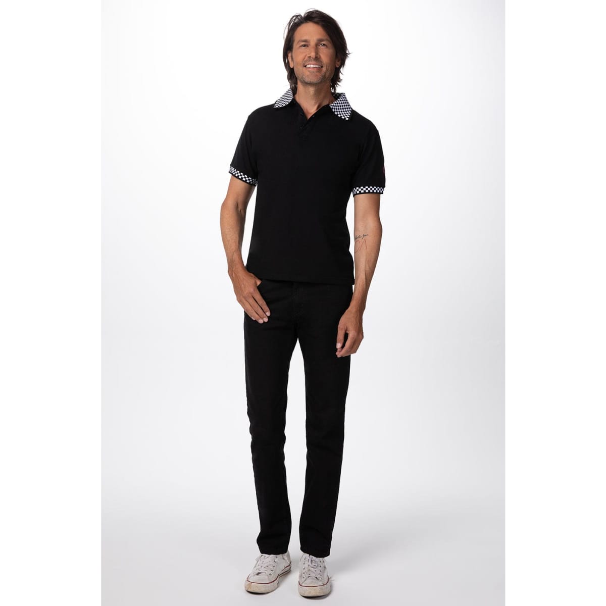 A black traditional men's polo shirt with contrasting patterned collar and sleeves displayed on a model.