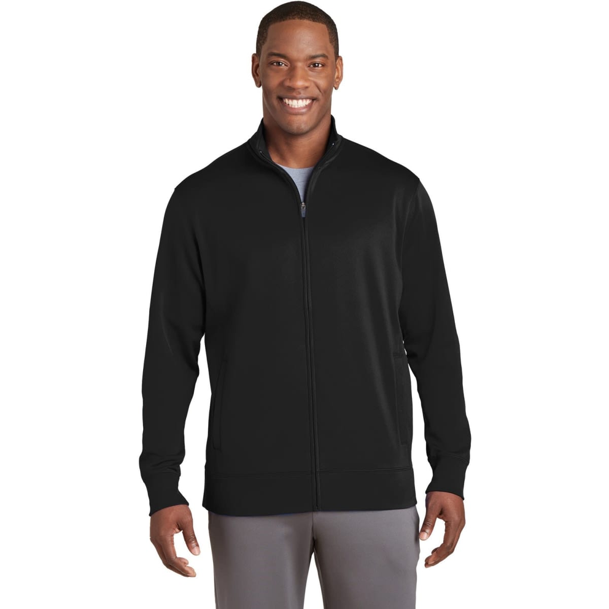 A man in a black Sport-Tek Sport-Wick fleece full-zip jacket stands smiling, showcasing the front design.