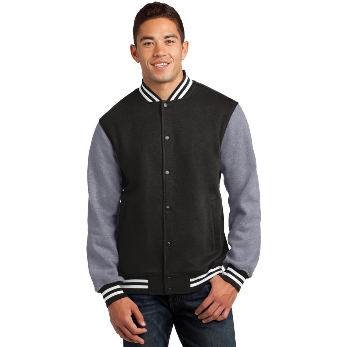 A man in a black and grey Sport-Tek fleece letterman jacket with a striped collar, featuring a logo.