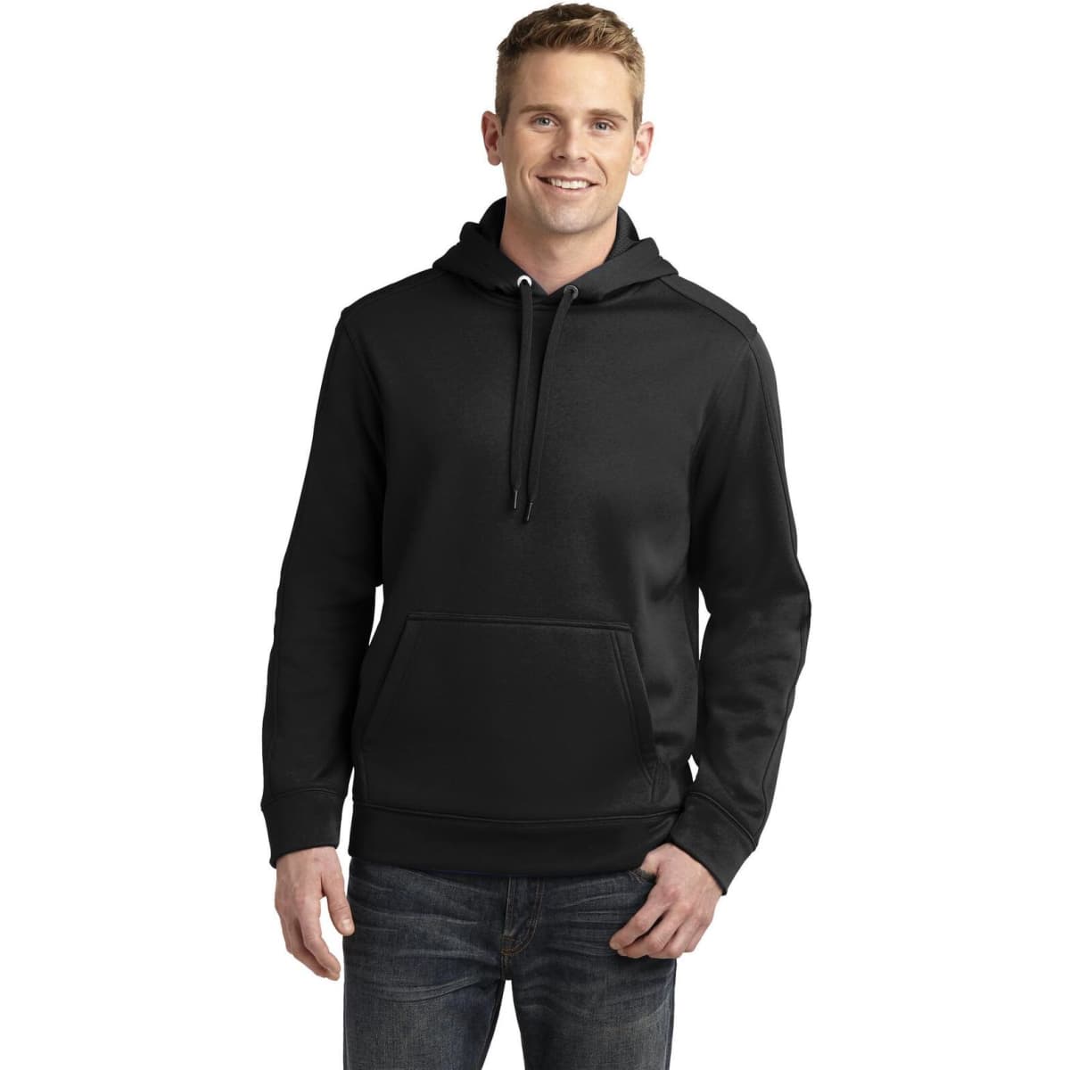 A man in a black hooded pullover with a front pocket and drawstrings, standing against a plain background.