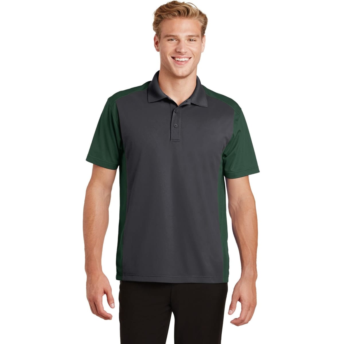 A man wearing a grey and green Sport-Tek Colorblock Micropique Sport-Wick Polo shirt, standing with a smile.