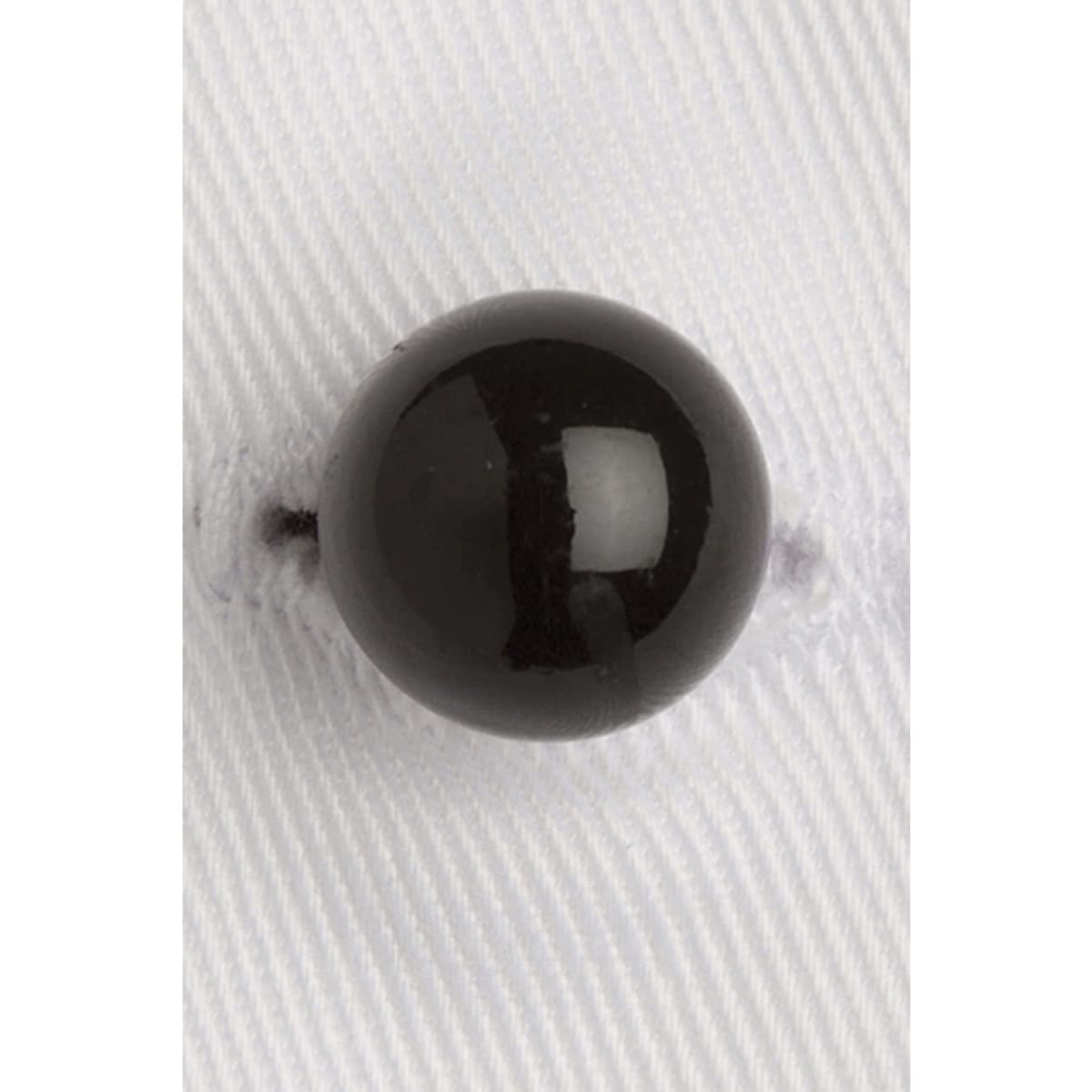 A black stud button on a white fabric background, featuring a glossy finish and a round shape.