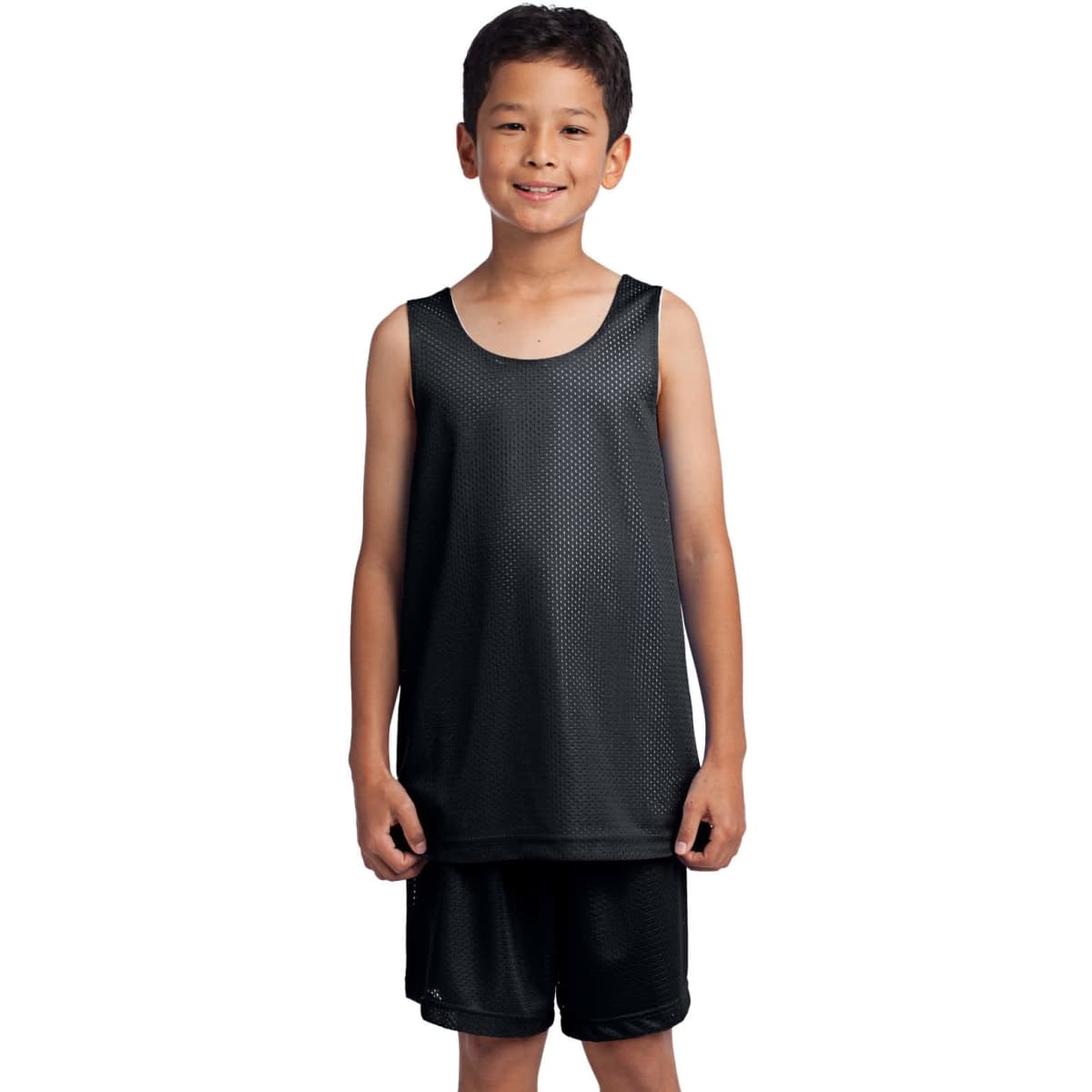 A youth stands in a black mesh reversible tank top, paired with black shorts, showcasing a sporty look.