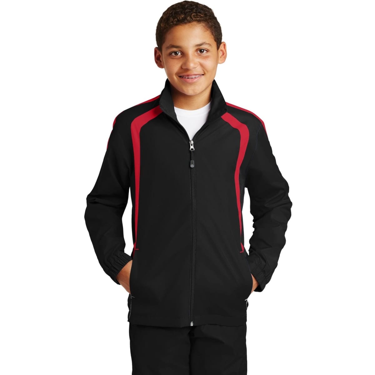 A youth track jacket in black with red colourblock detailing, featuring a zip front and side pockets.