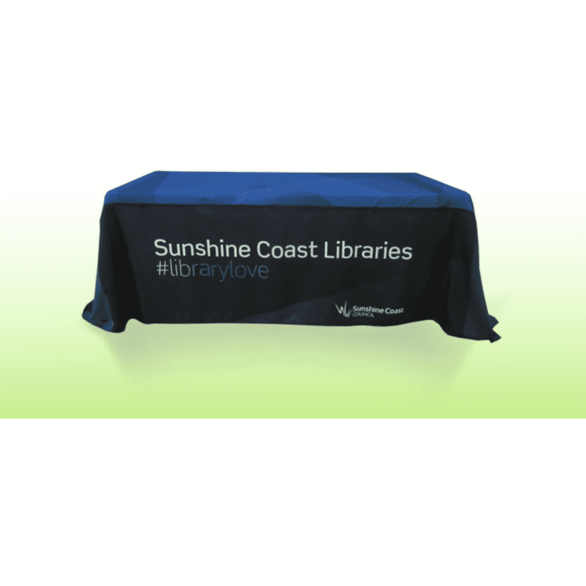 A blue and black tablecloth featuring a logo and text promoting Sunshine Coast Libraries, on a gradient background.