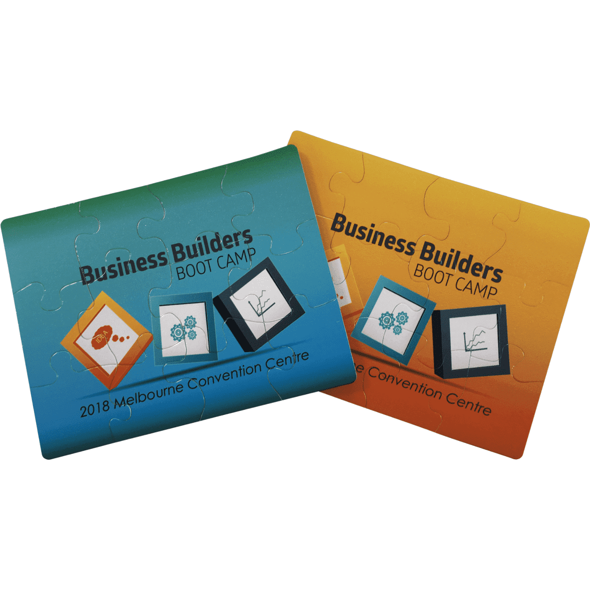 A jigsaw puzzle set featuring two designs, one in blue and the other in orange, with a logo on each piece.