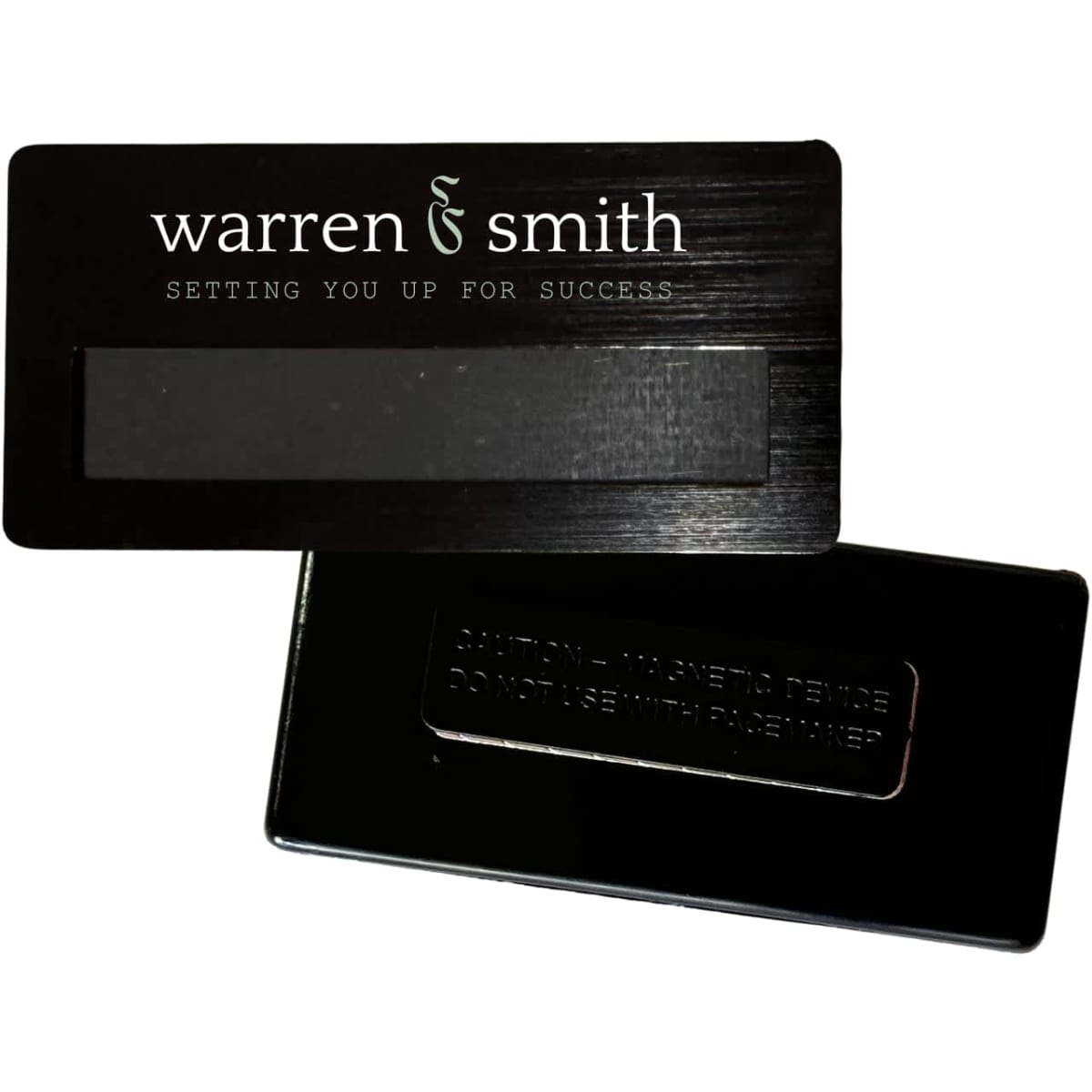 A black DIY staff badge measuring 75x36mm with a magnetic backing and an understated design.