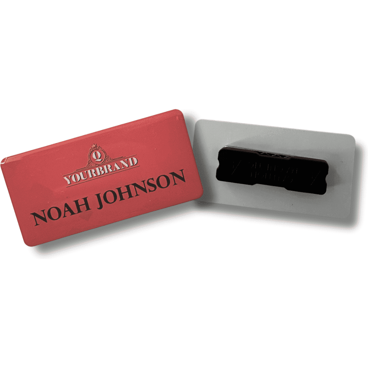 A red plastic staff badge with a black magnet on the back. It features a logo and a name.