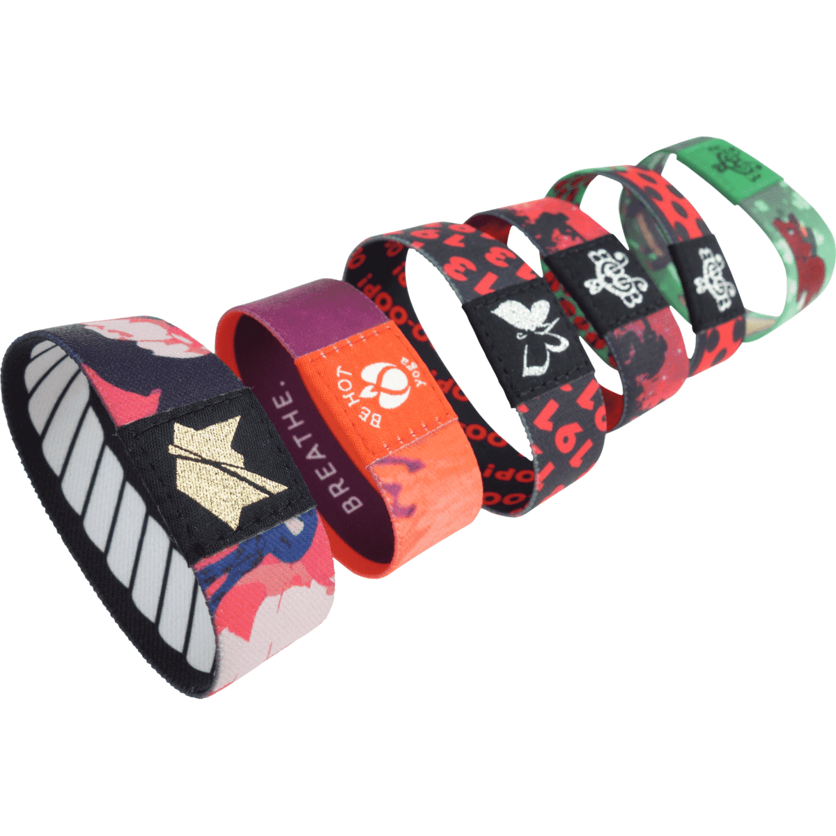 A collection of multicoloured elastic wristbands, featuring various designs and a small logo on each band.