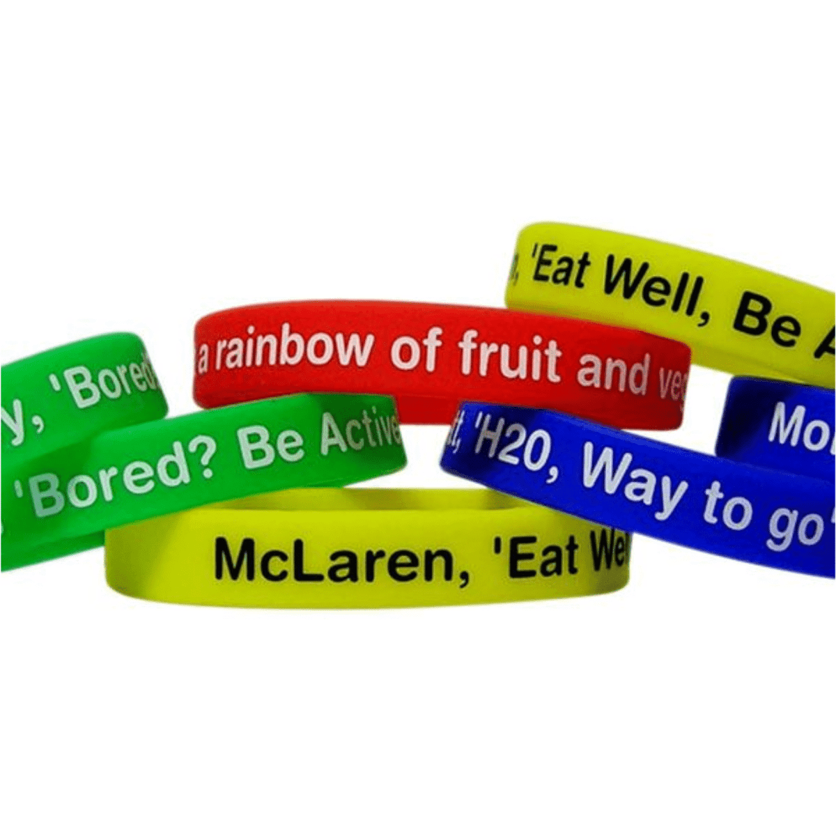 A collection of silicone wristbands in green, red, yellow, and blue, with various printed messages and logos.