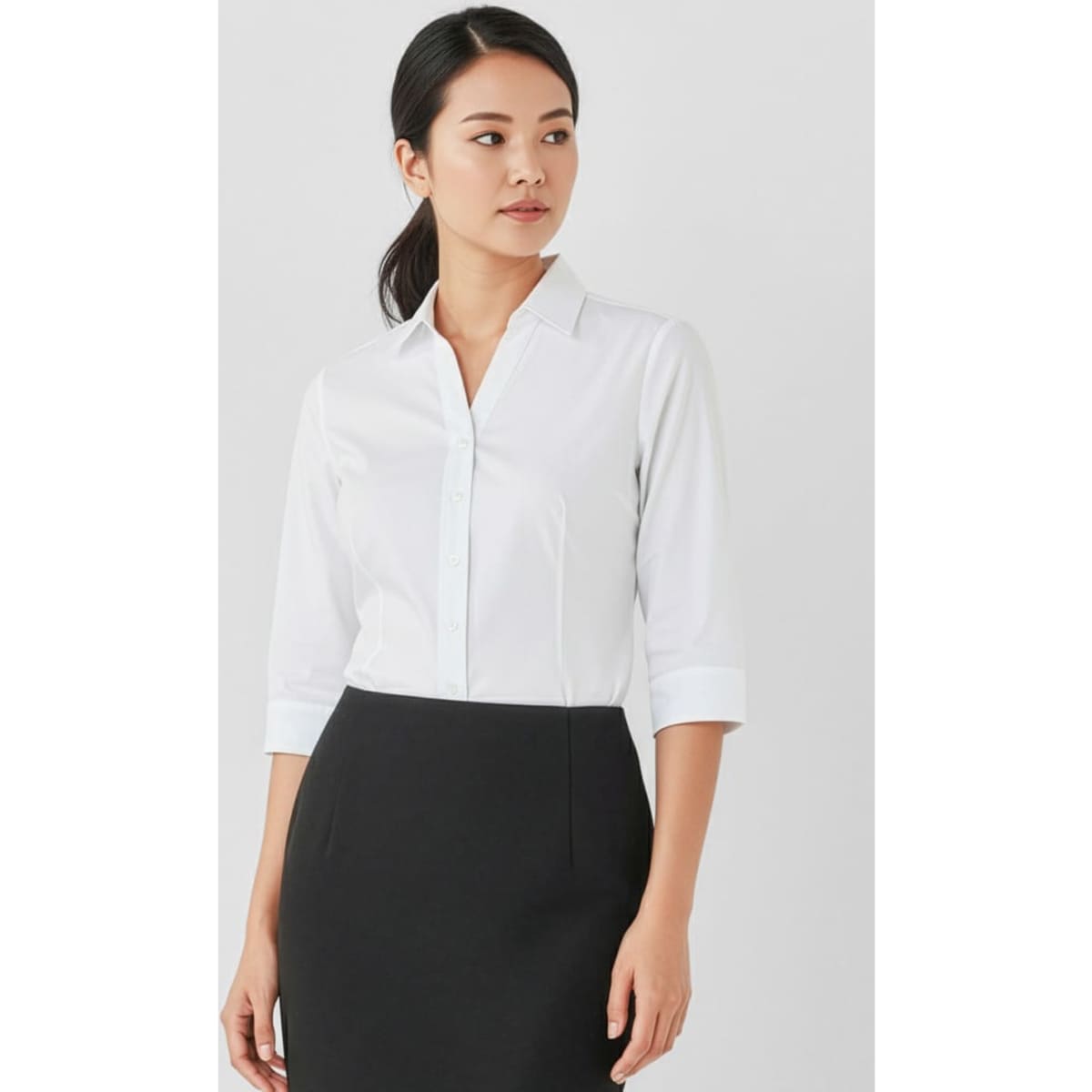 A white women's button-up shirt with 3/4 sleeves, featuring a simple and elegant design, paired with a black skirt.