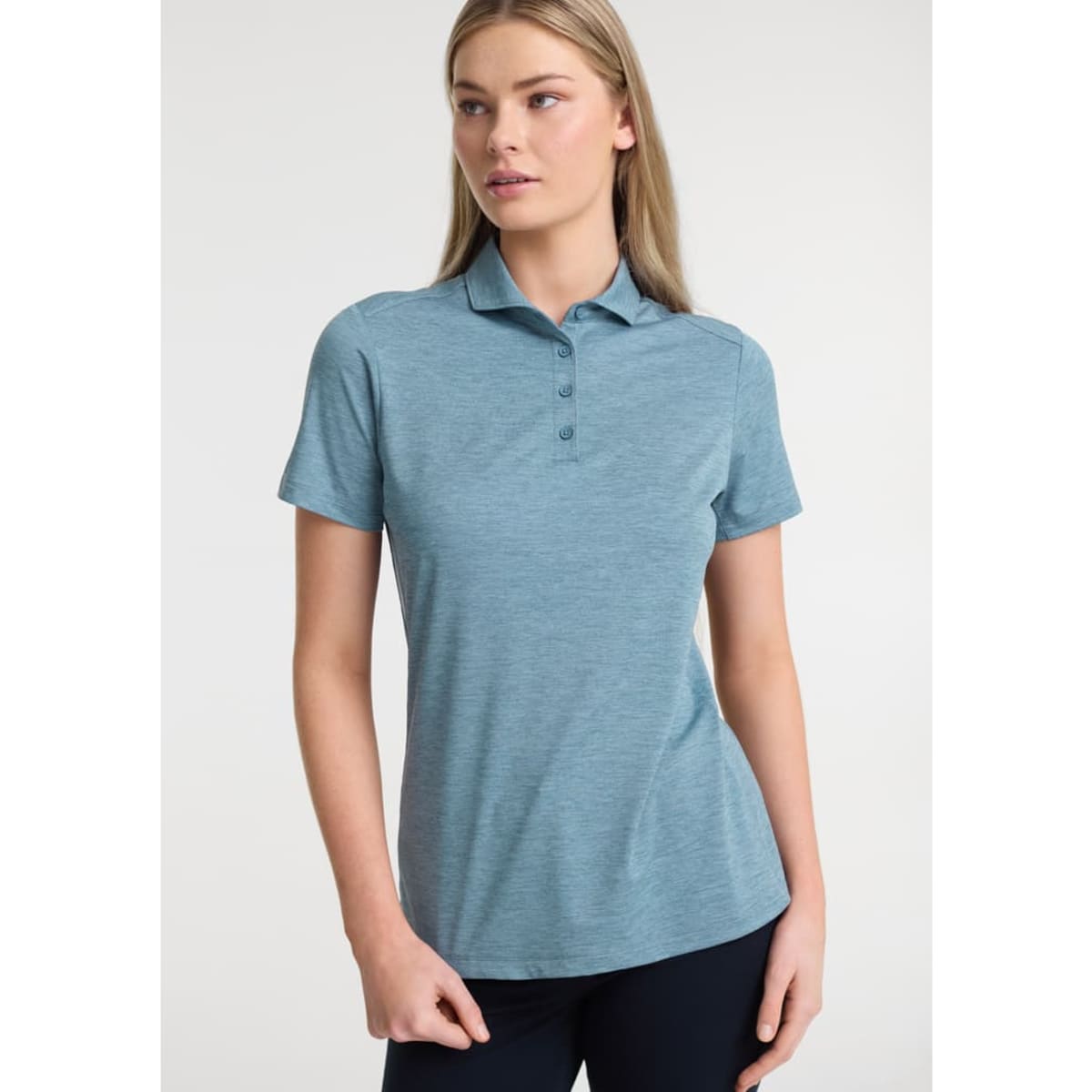 A women’s short sleeve polo in a light blue colour featuring a classic collar and a subtle logo.