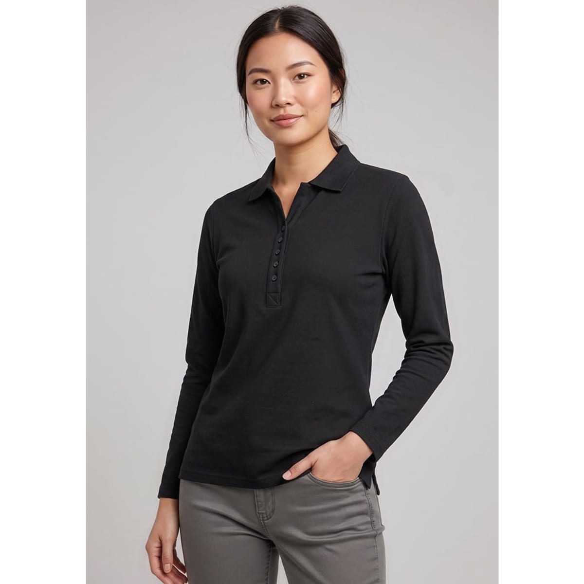 A long sleeve women's polo shirt in black, featuring a buttoned placket and a subtle logo.