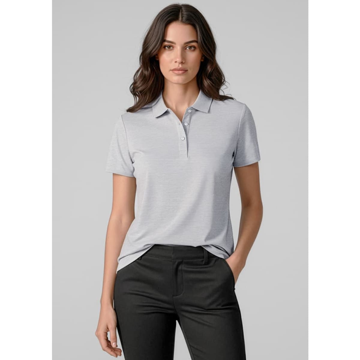 A women's short sleeve polo shirt in light grey, featuring a collar and a logo. Paired with black trousers.