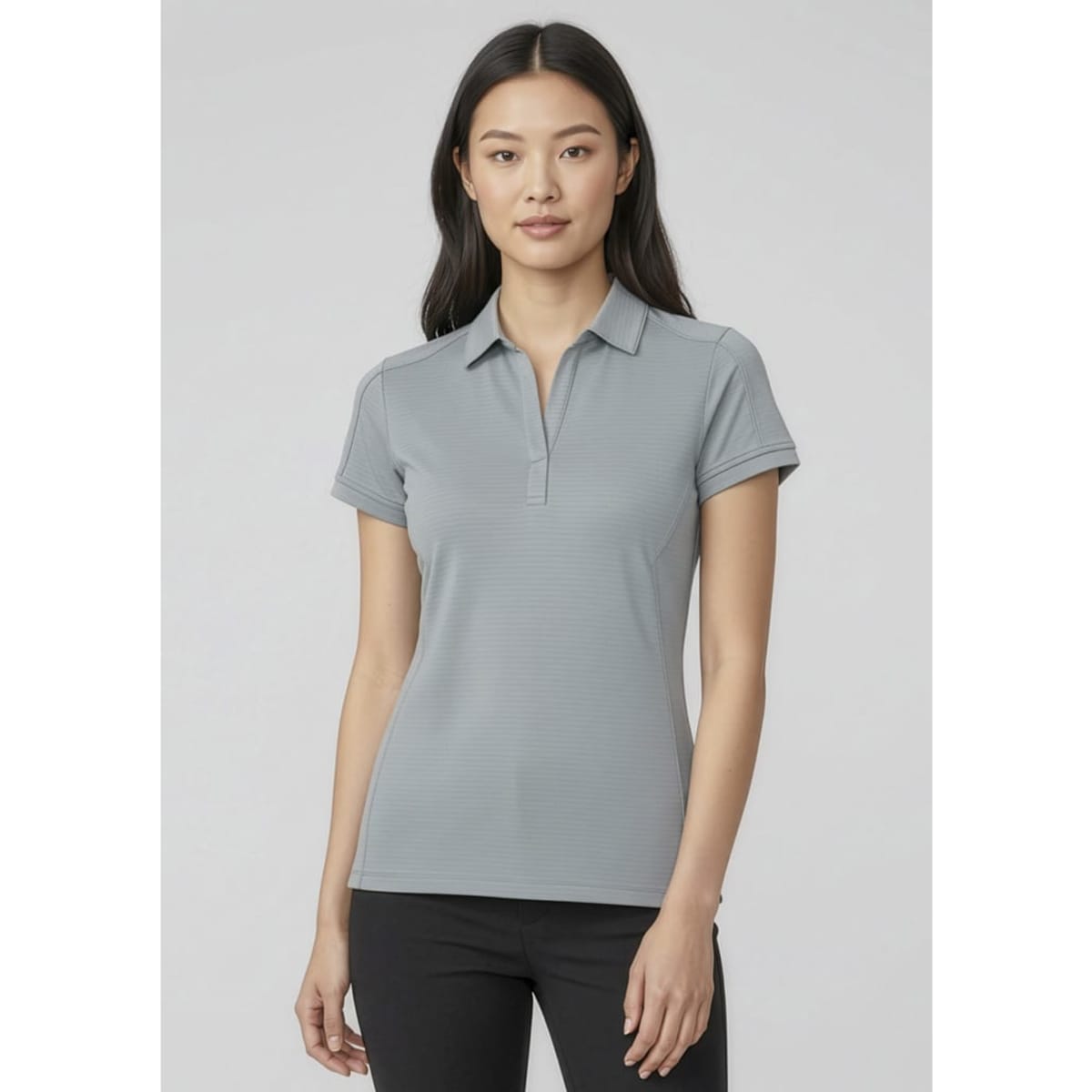 A women's short sleeve polo shirt in grey, featuring a classic collar and fitted design. It has a logo on it.