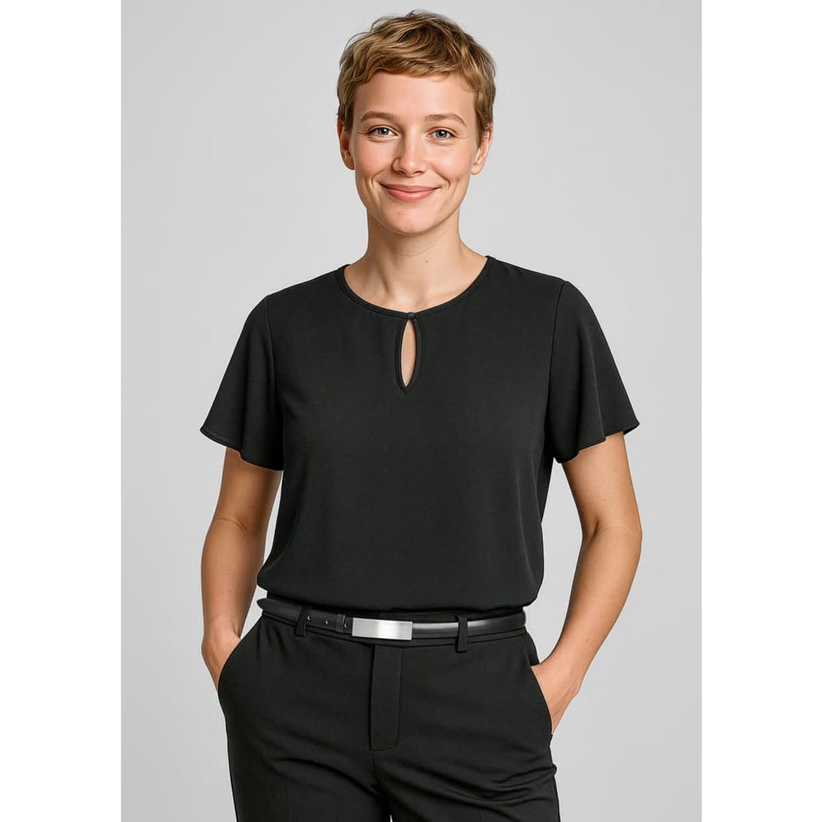 A black short sleeve blouse featuring a keyhole detail at the neckline, accompanied by a person wearing tailored trousers.