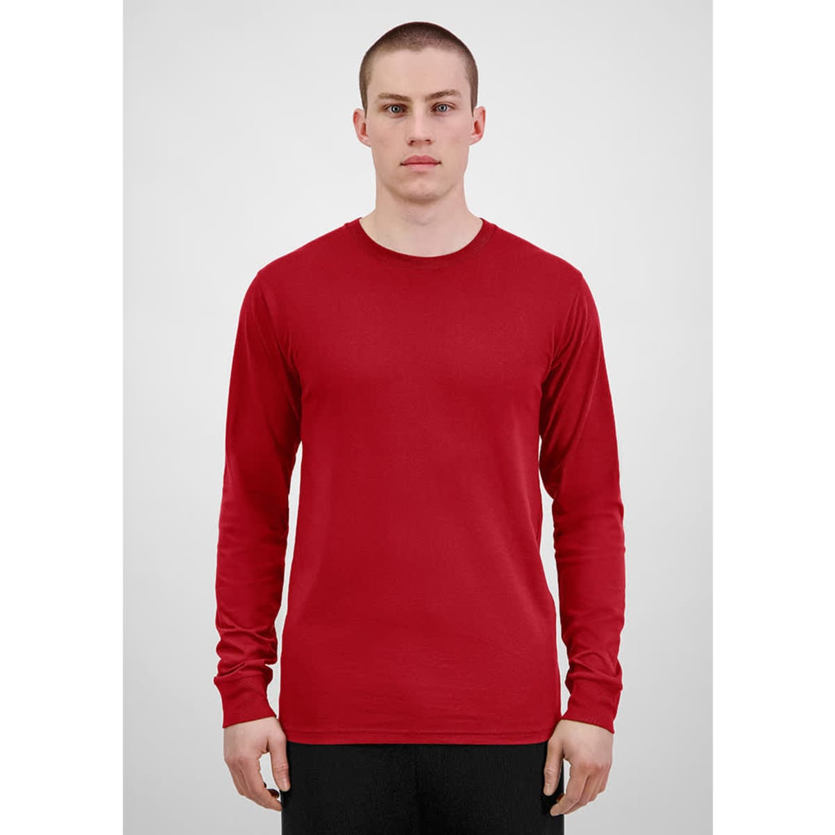 A red long sleeve men's tee featuring a simple design and fitted style. It has a branding logo.