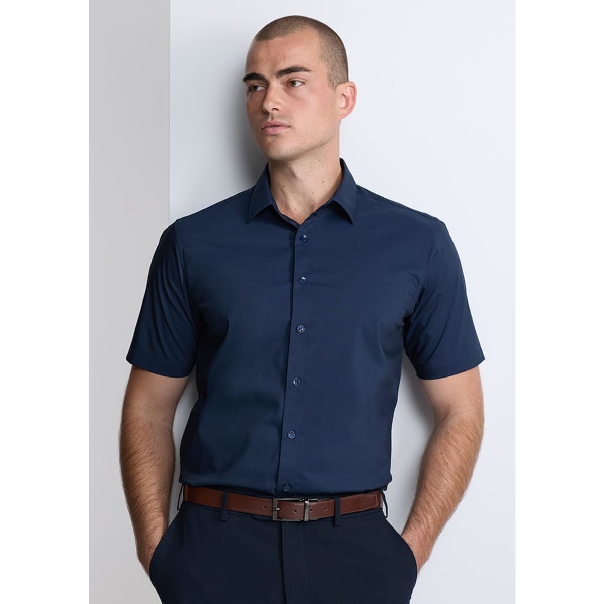 A classic fit short sleeve shirt in navy, featuring a button-up front and a subtle branding logo.