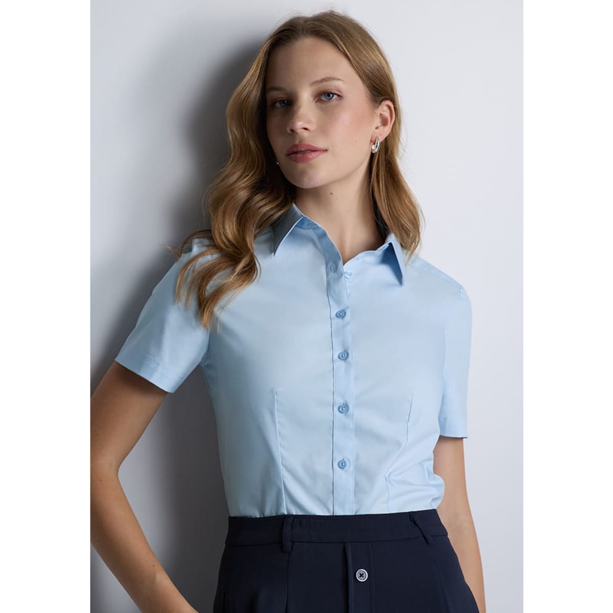 A short sleeve women's shirt in light blue with a collared neckline and button-up front details.