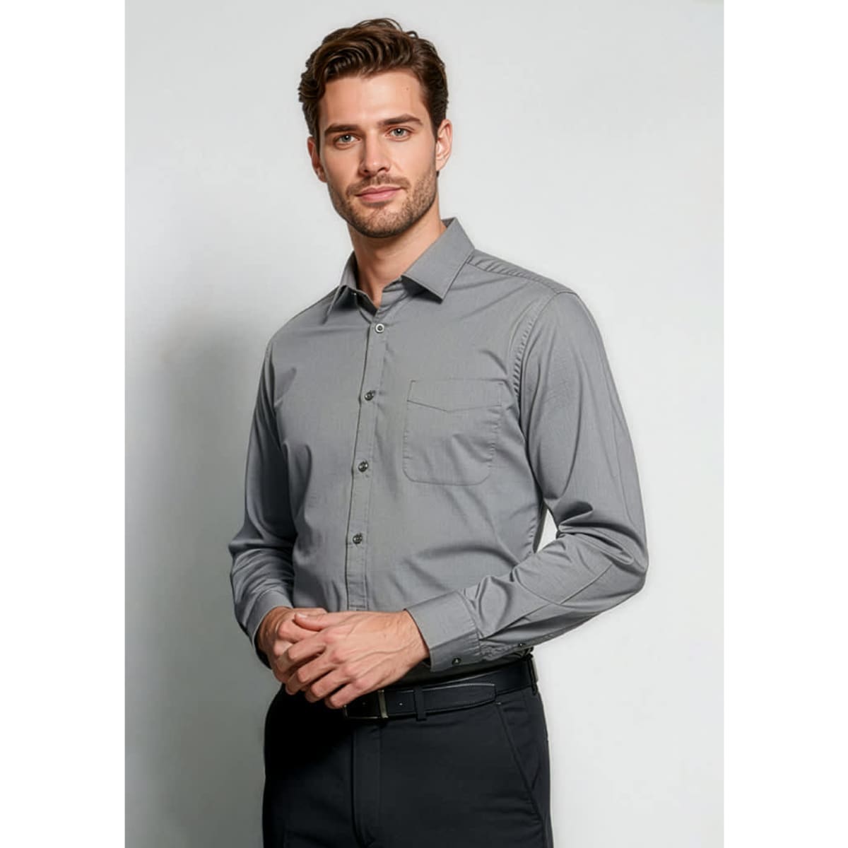 A grey long sleeve button-up shirt with a chest pocket, featuring a logo on the upper left.