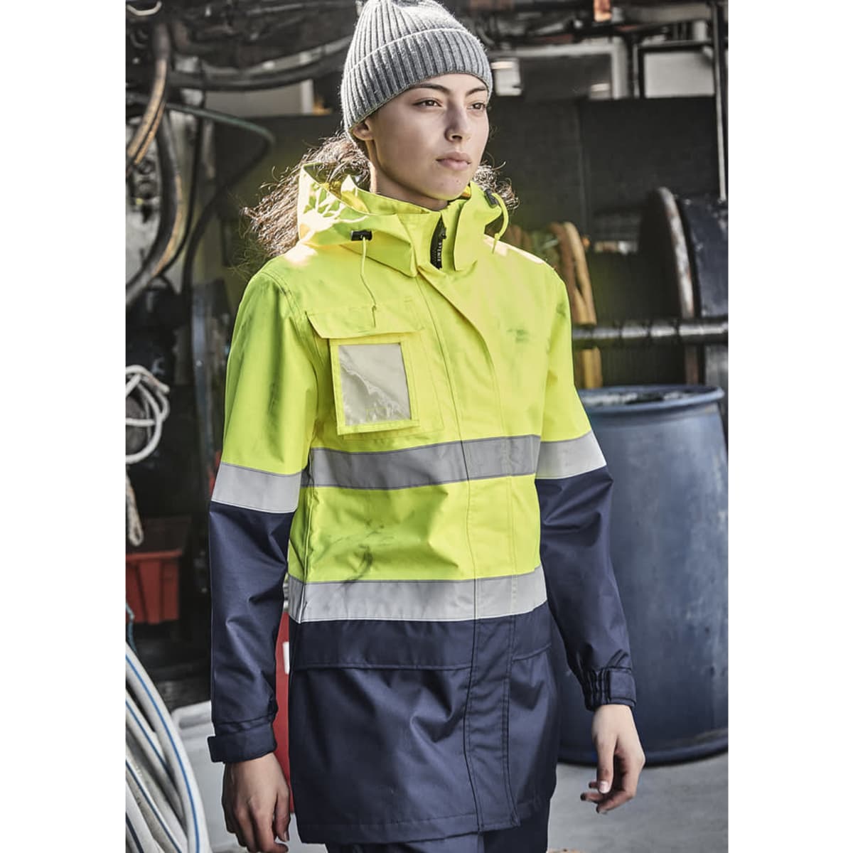 A women's hi-vis ultralite waterproof jacket in bright yellow and navy, featuring reflective stripes and a hood.