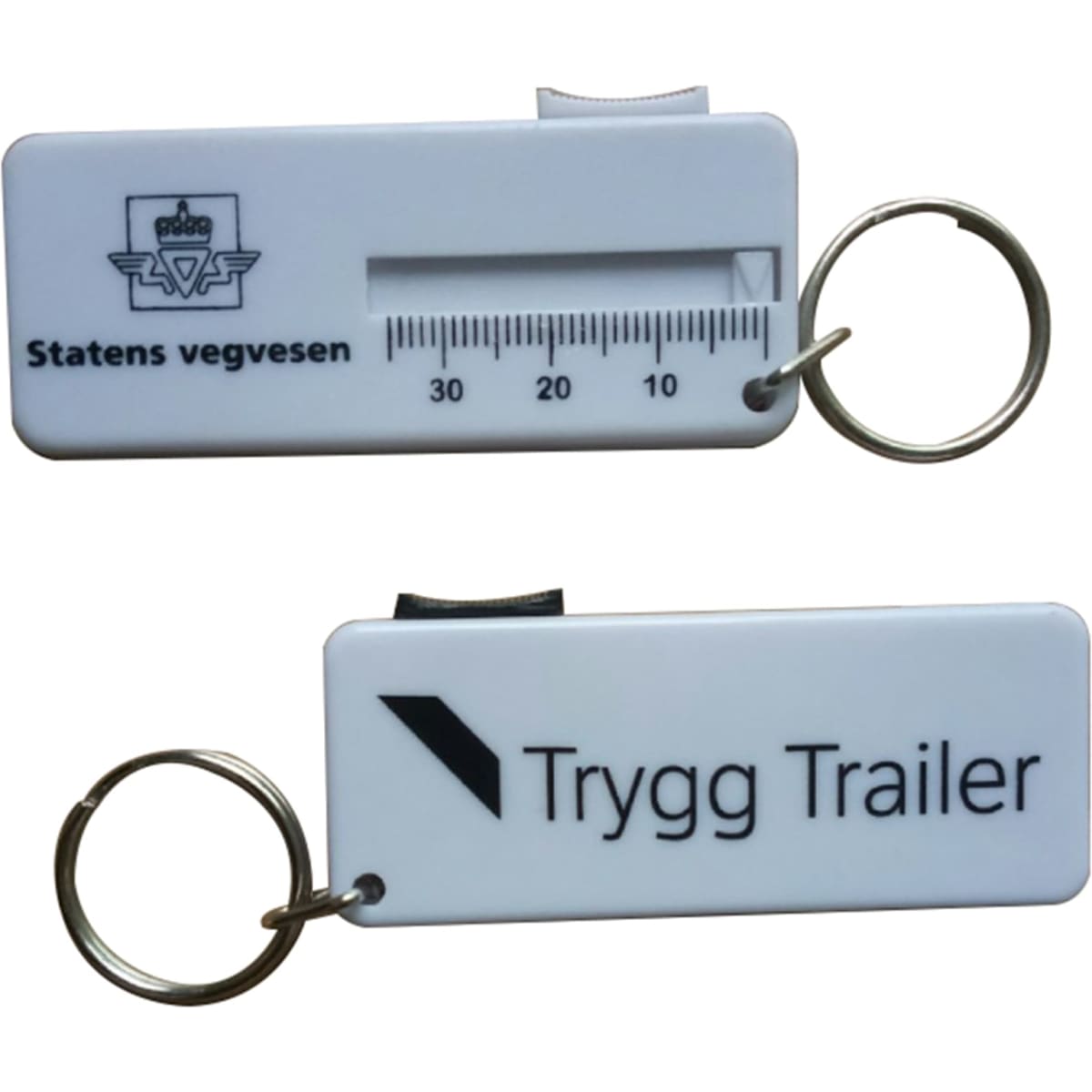 A white plastic tire gauge with a keyring attachment, featuring measurement markings and a logo on one side.