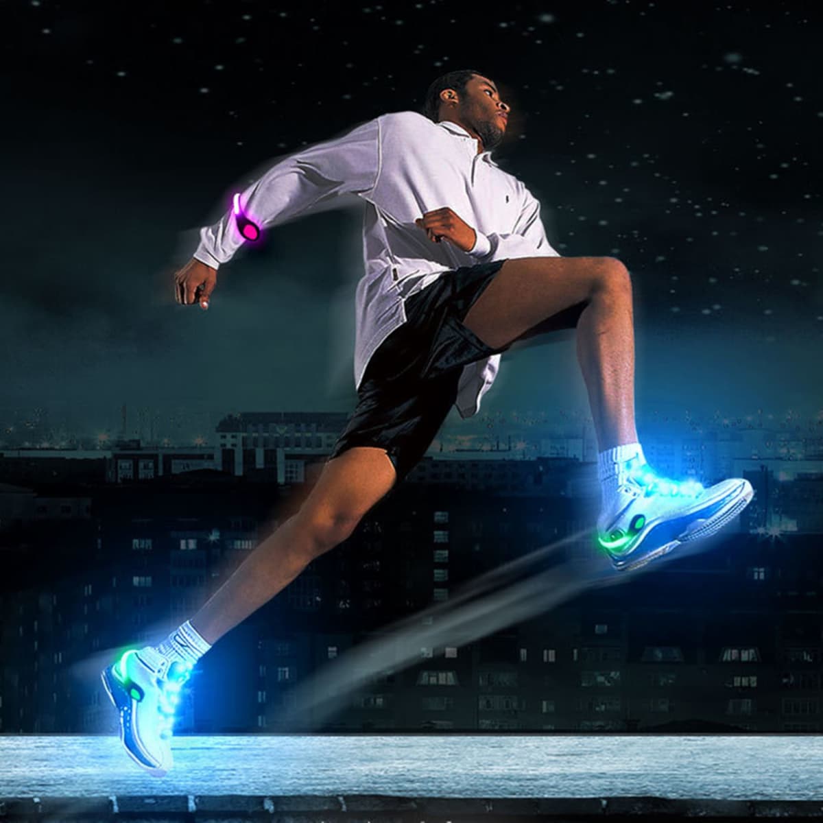A runner in a white jacket and black shorts wears vibrant LED clip-on shoe lights, illuminating the scene in various colours.
