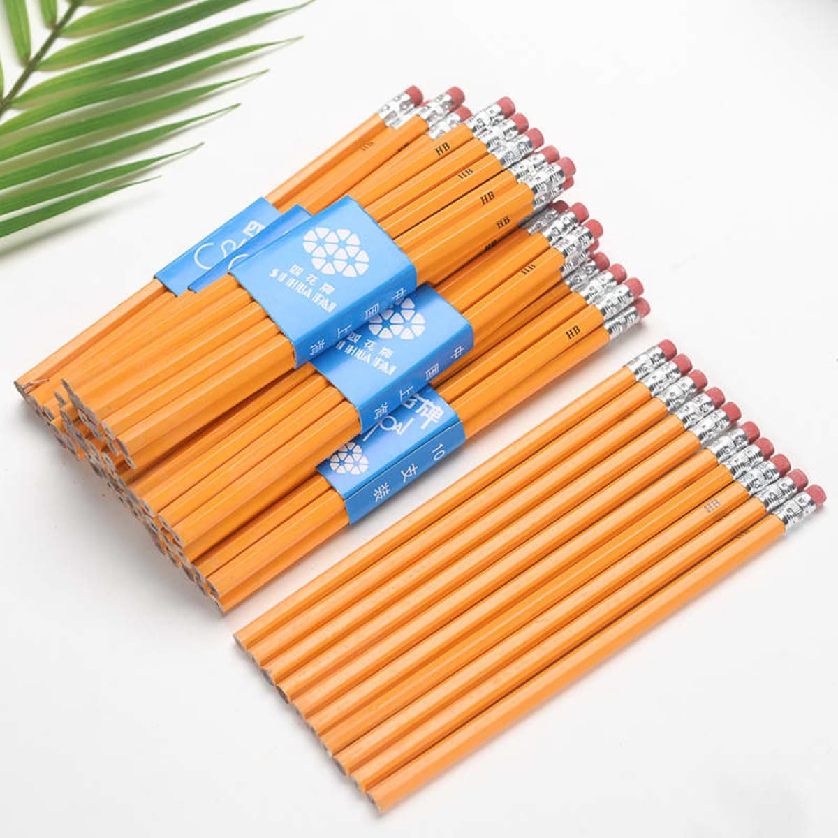 A bundle of round orange pencils with erasers, featuring a logo on a label.