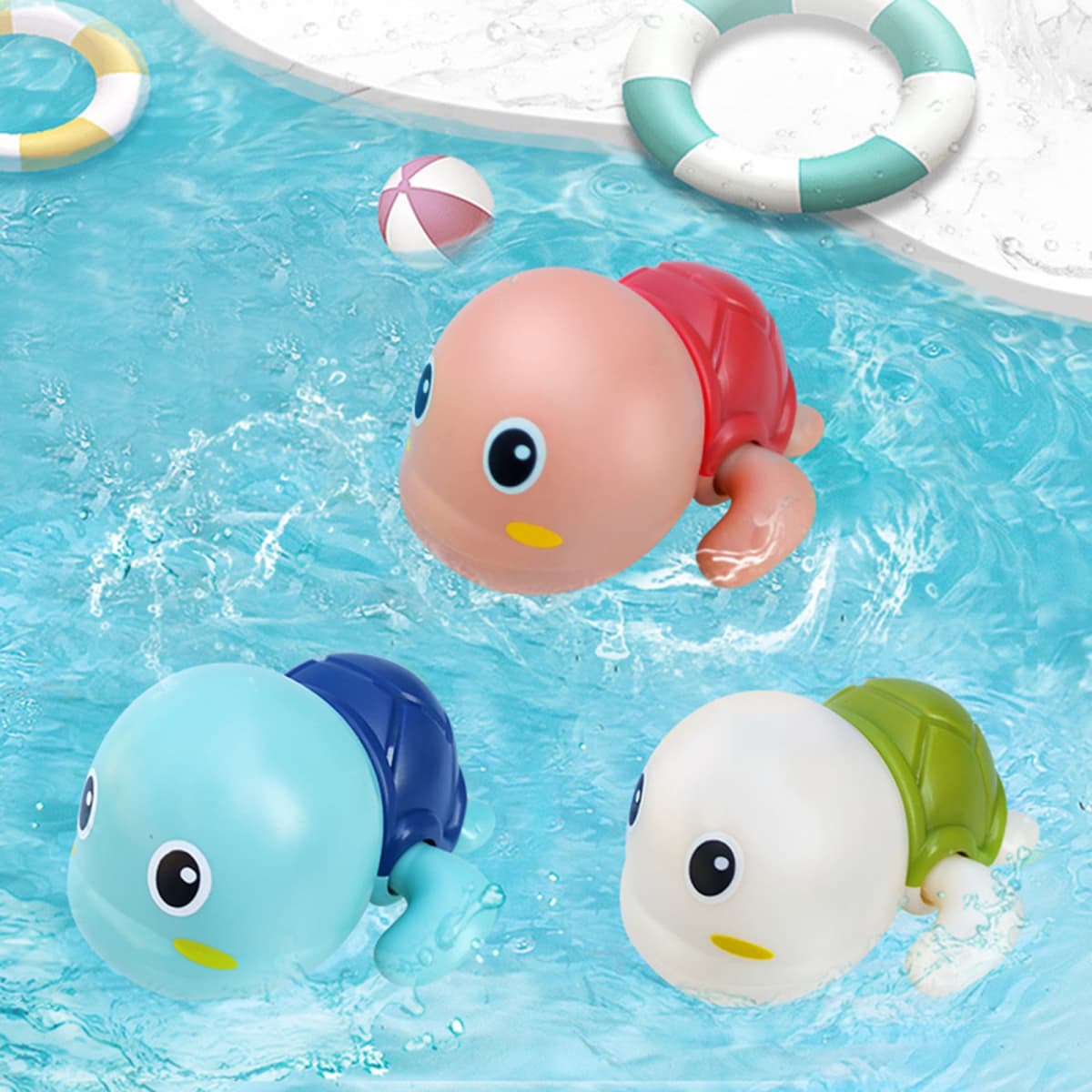 Three colourful swimming tortoise toys in blue, green, and pink, floating in a pool of water.
