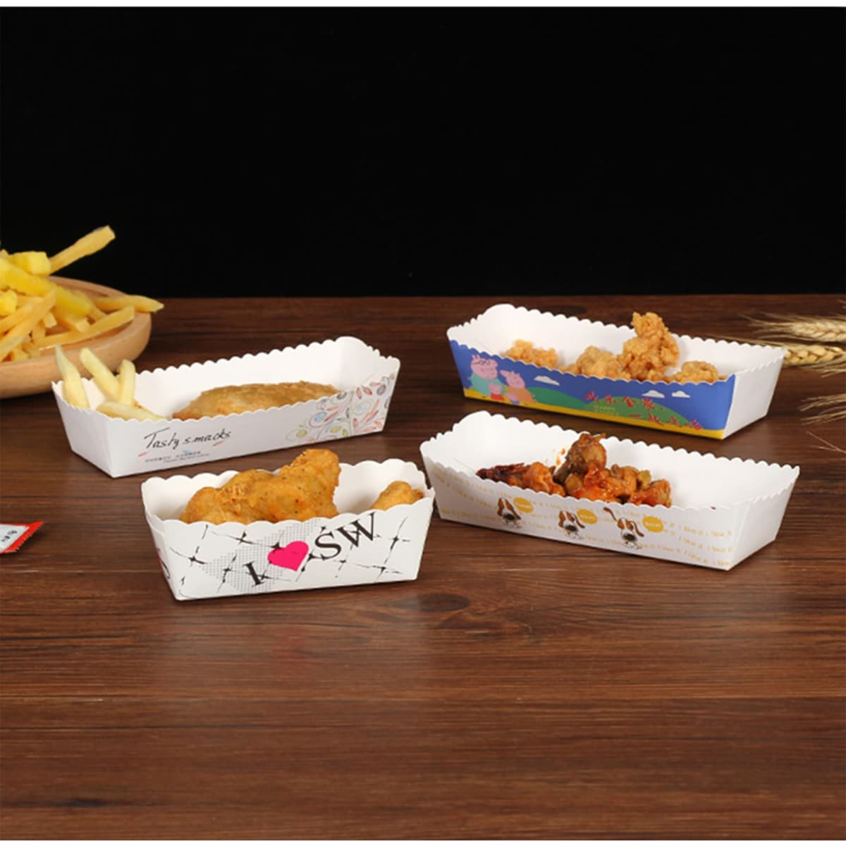 A collection of white food trays in various designs, containing fried chicken, chips, and other snacks.