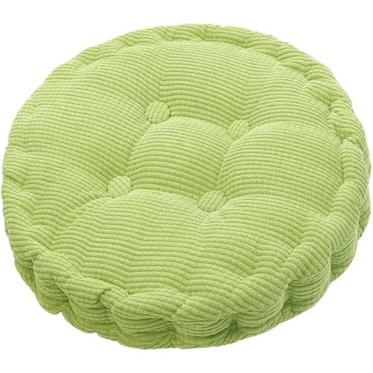 A round seat cushion in a light green colour with a textured, quilted surface and button detailing.