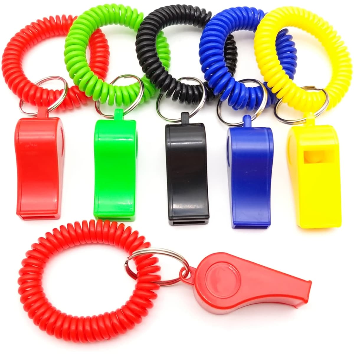 A collection of novelty whistles in red, green, black, blue, and yellow, each attached to a coiled keyring.