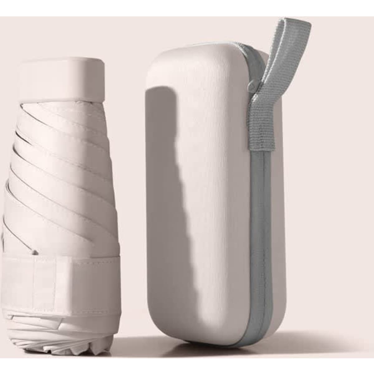 A mini umbrella in a white carrying case, featuring a zip closure and a handle for easy transport.