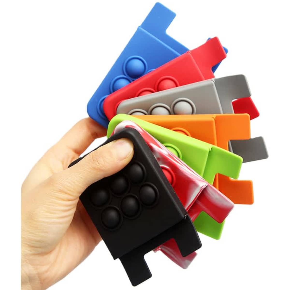 A hand holding a variety of colourful custom push pop phone wallets in red, blue, green, orange, grey, and black.