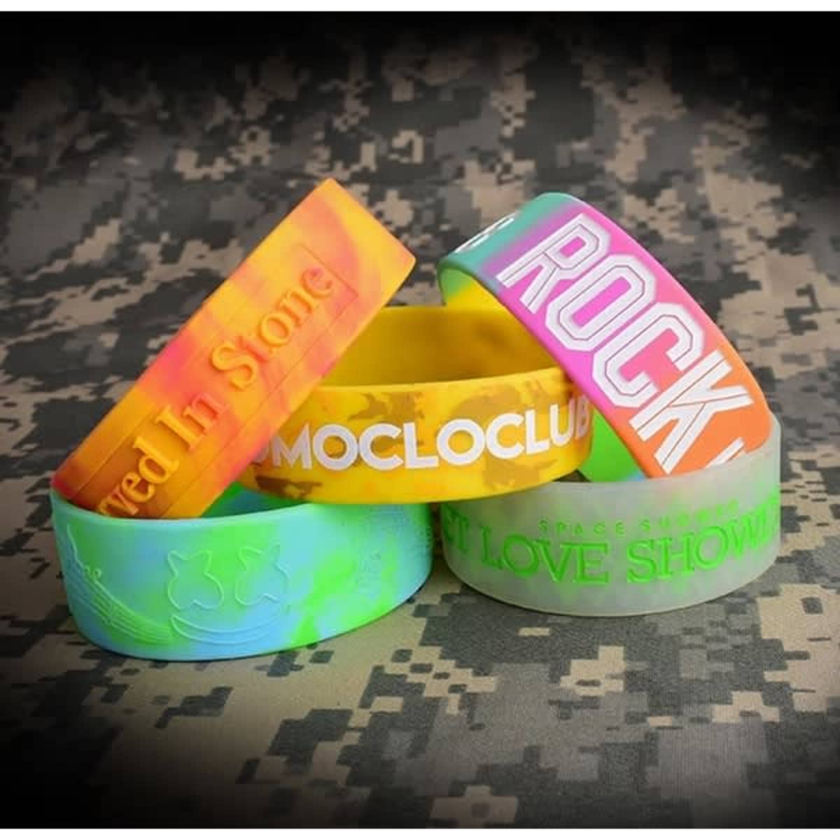 A collection of colourful silicone wristbands in various designs and colours, featuring different textures and patterns.