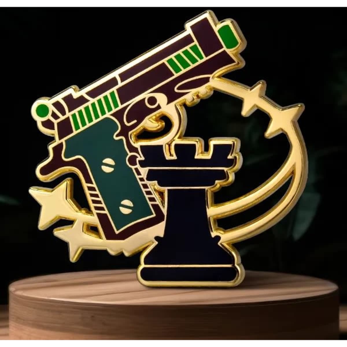 A gold and coloured enamel lapel pin featuring a gun and a castle piece, set against a dark background.