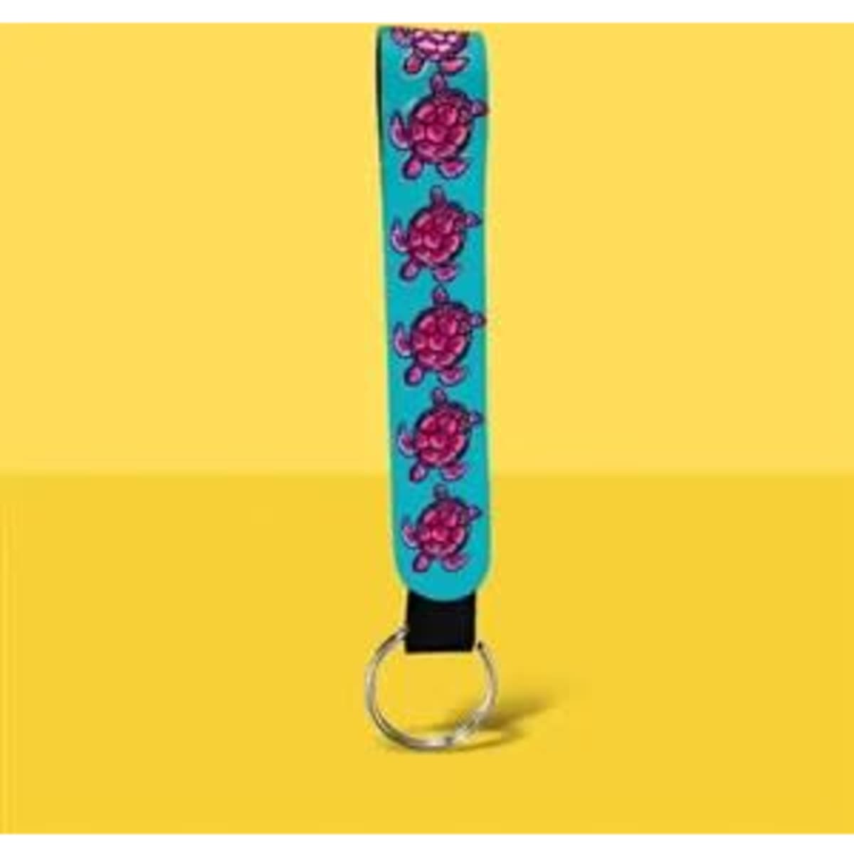 A turquoise neoprene wristlet keychain lanyard featuring pink turtle designs and a metal ring.