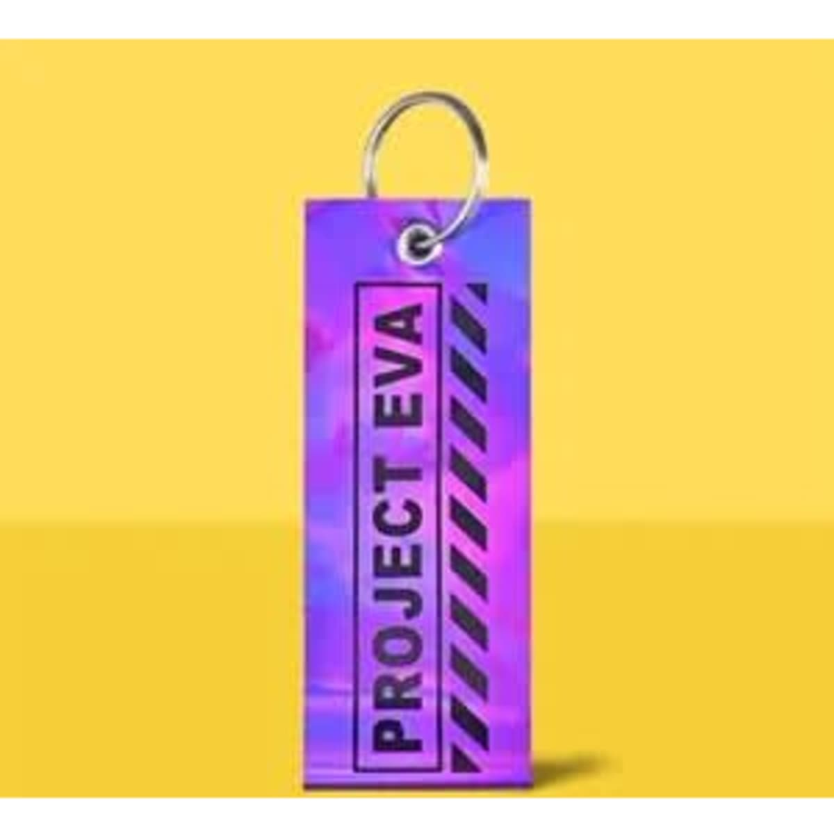 A vibrant purple and pink PVC keychain with a metal ring, featuring a logo and striped design.