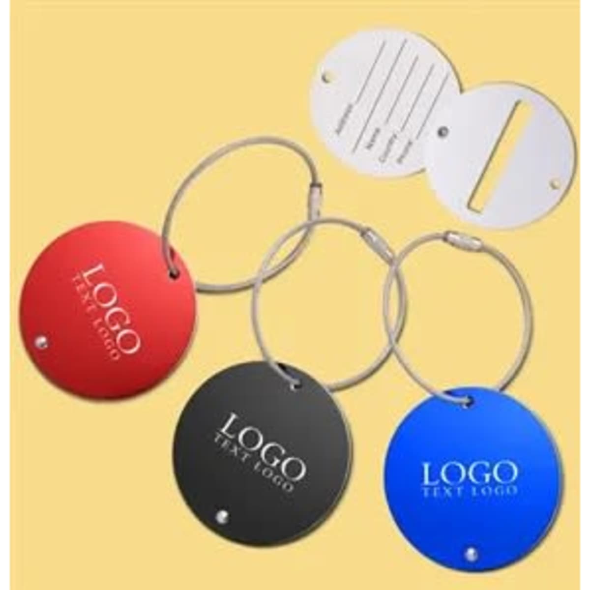 Three round aluminium luggage tags in red, black, and blue, each with a metal loop and a branded logo.