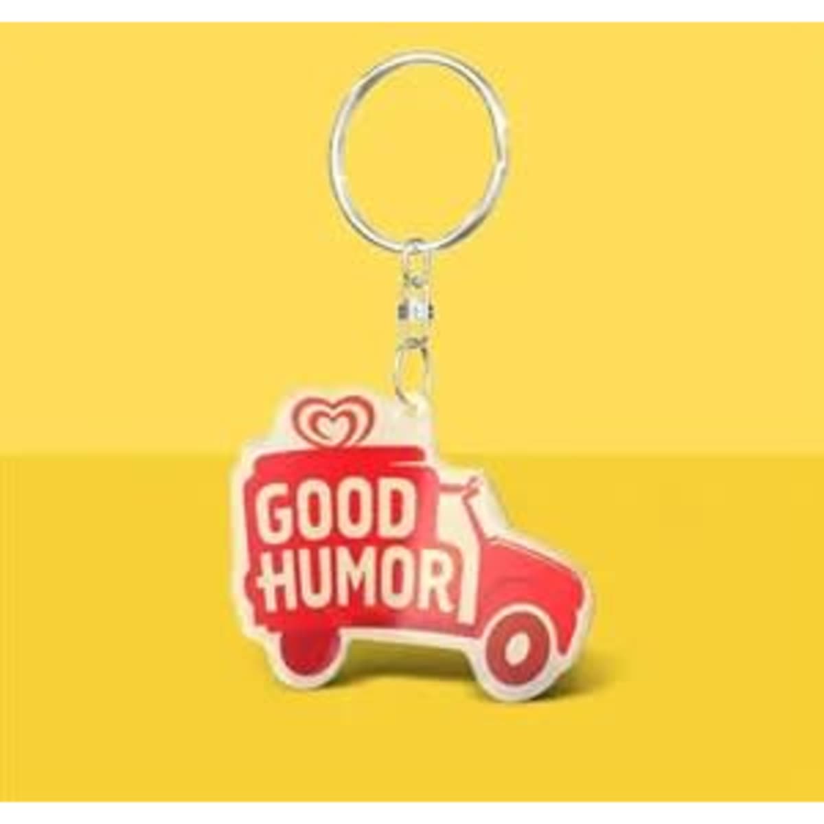 A custom acrylic keychain shaped like an ice cream truck, predominantly red with yellow and white details.