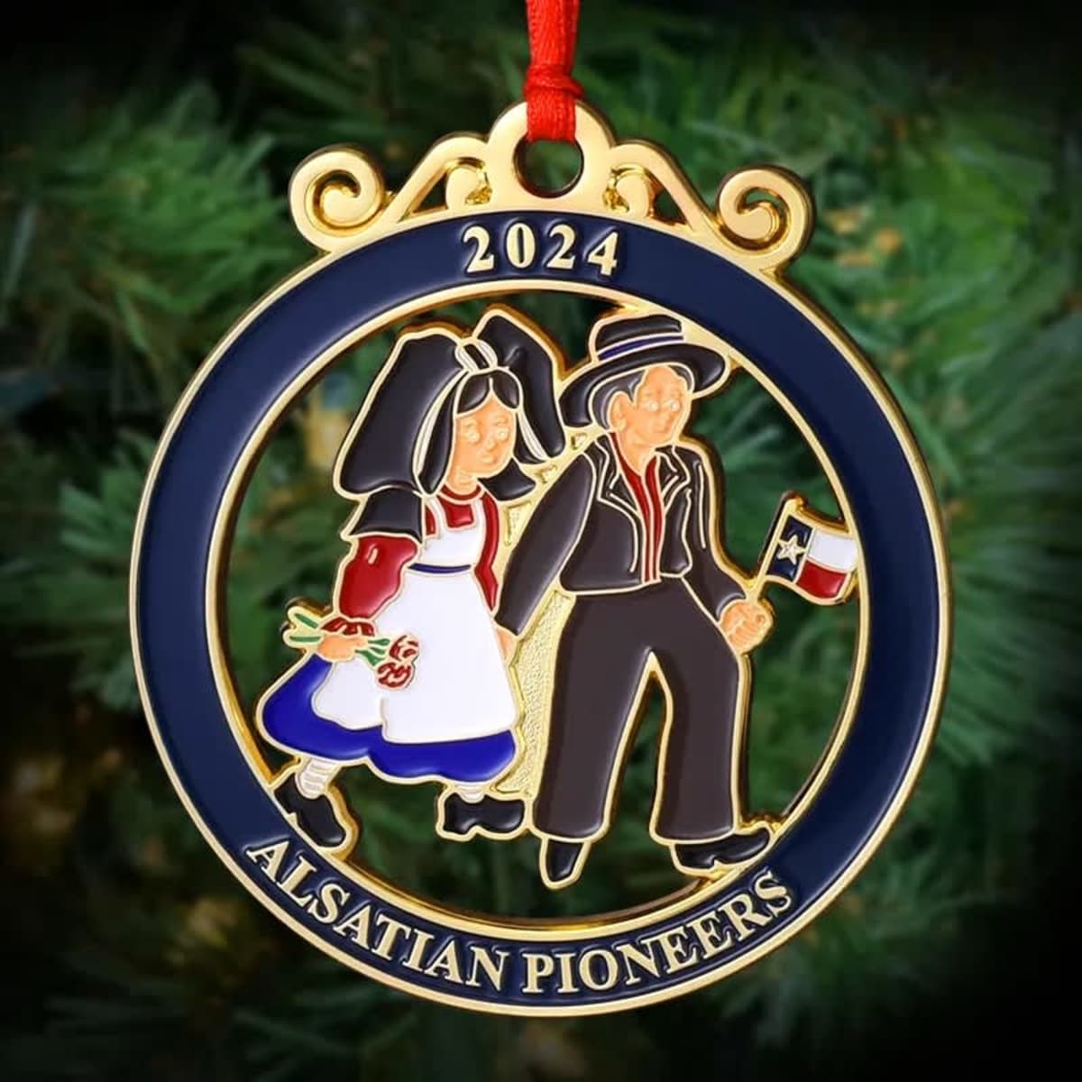 A custom die cast ornament featuring a blue and gold design with characters in traditional attire, holding a flag.