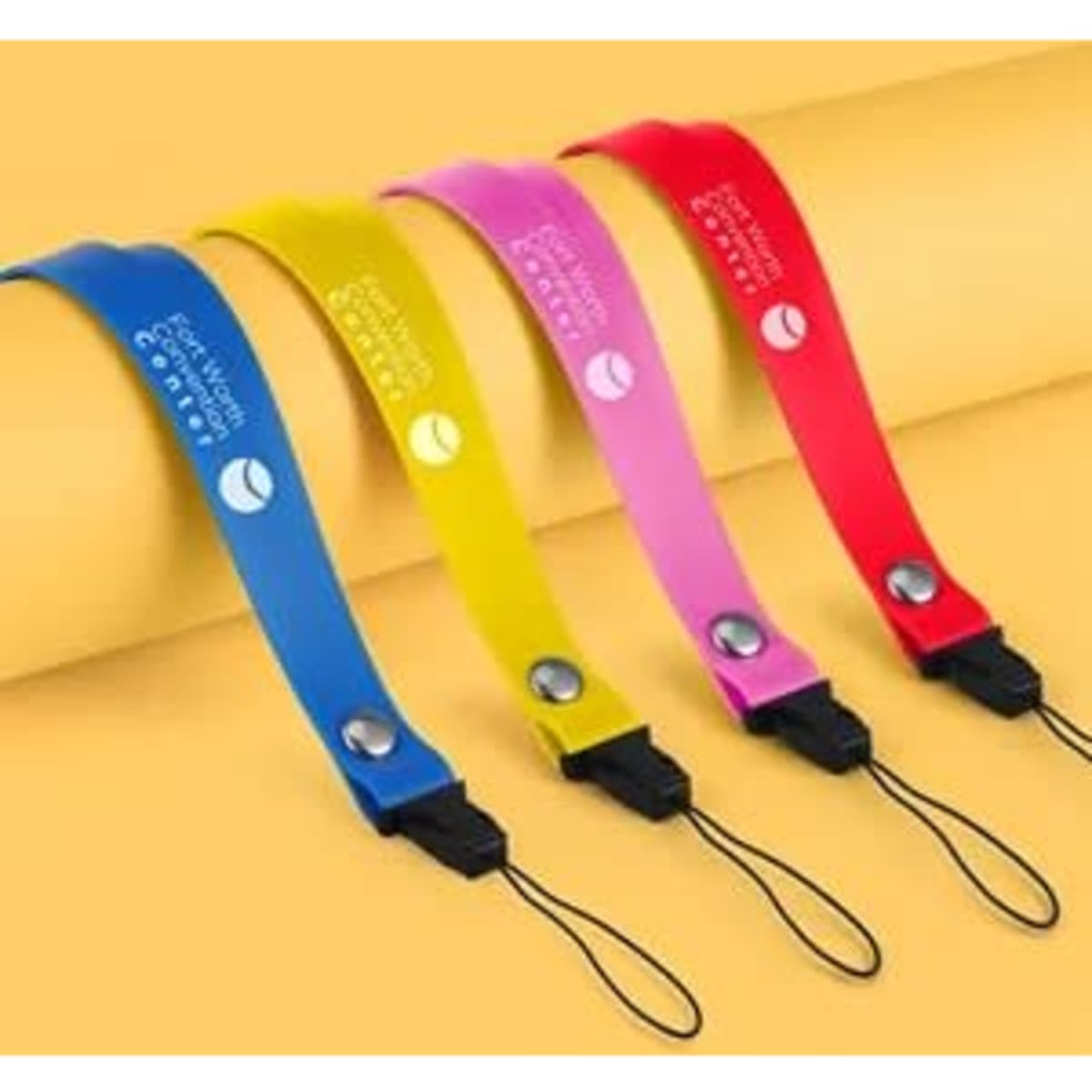 Silicone lanyards in blue, yellow, pink, and red, featuring safety breakaway features and a logo.
