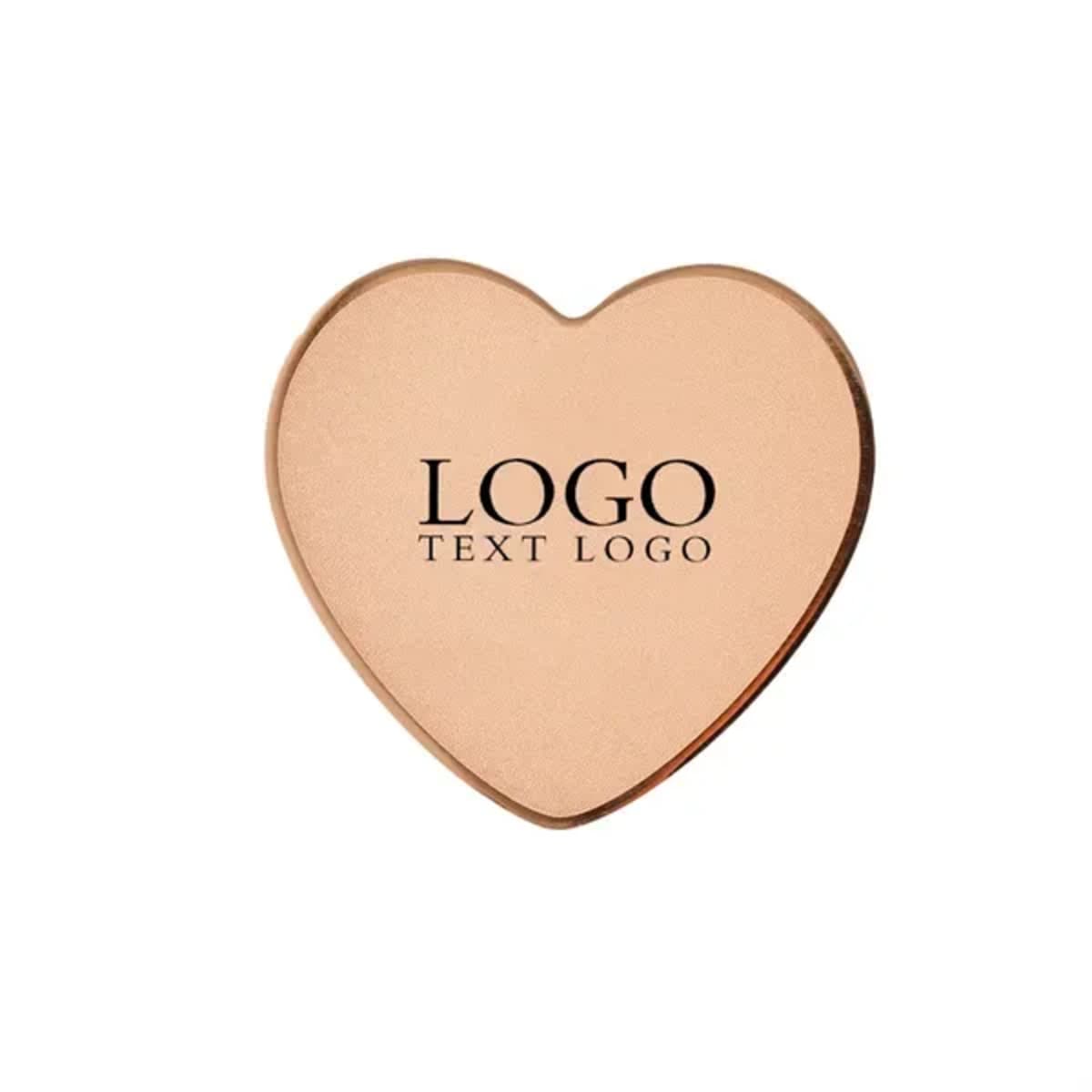 A heart-shaped stainless steel name badge in rose gold with a logo.