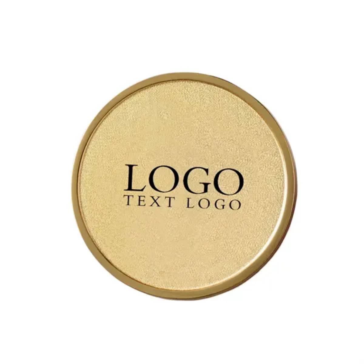 A round, gold die struck name badge with a logo and text centrally displayed.